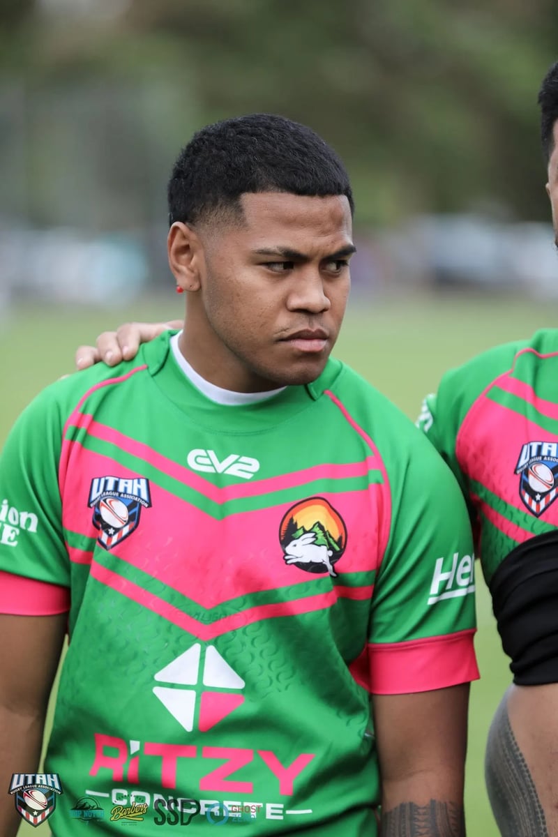 Hands rest on a young Rabbitahz player's shoulders in the team circle