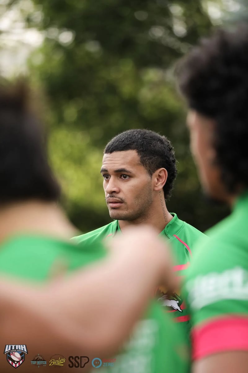 Close portrait of a Rabbitahz player in green and red framed between blurred teammates' shoulders