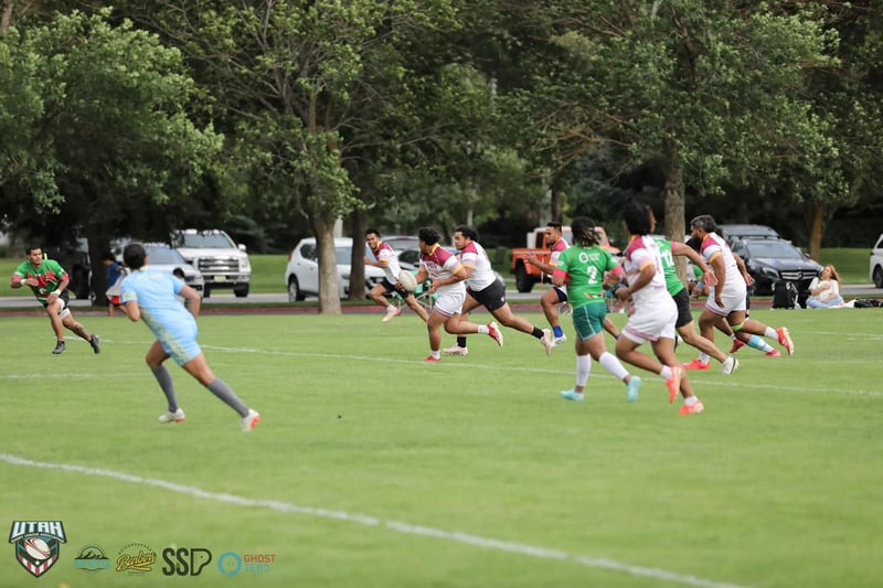 Broncos in white and Rabbitahz in green sprint downfield together in an end-to-end passage of preseason play.