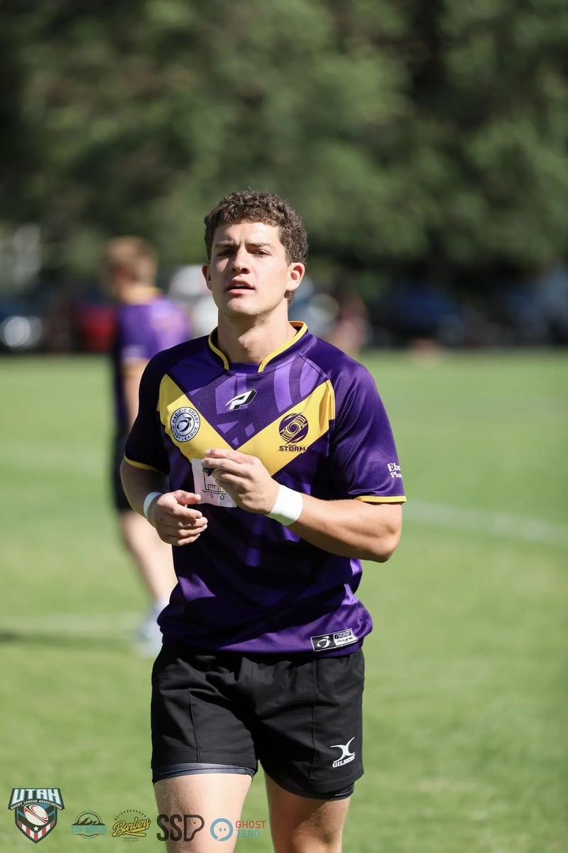 Player in a purple and gold jersey with taped wrists jogs across the field between plays