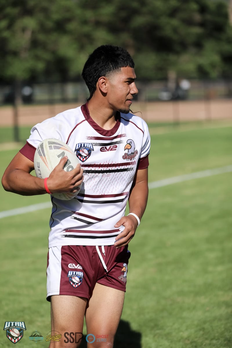 A Riverton Seagulls player in white and maroon walks the ball back with the tee out wide.