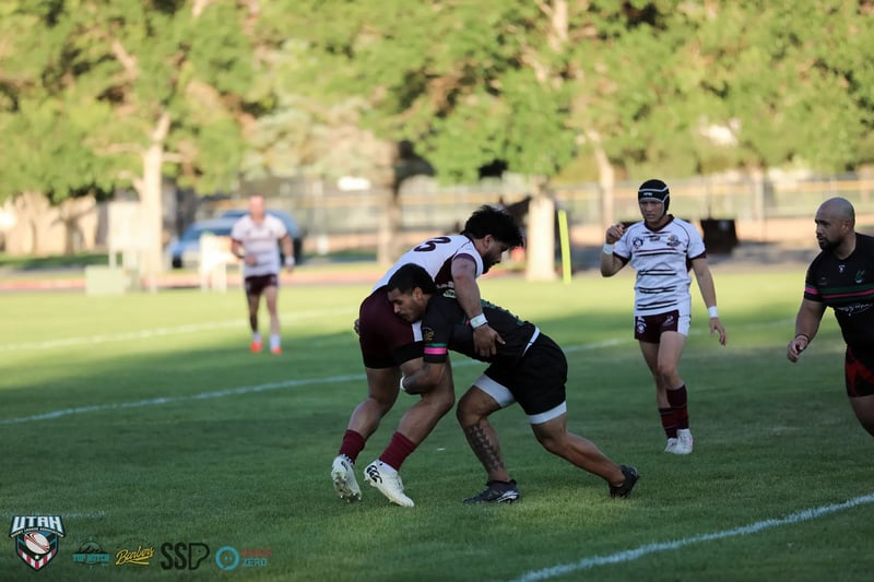 A Bluffdale Rabbitahz ballcarrier is brought down in a tackle by the Riverton Seagulls defence.