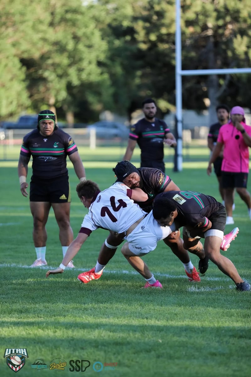A Seagulls forward in white and maroon is hit low by two Rabbitahz tacklers in dark green-and-red kit at the moment of contact.