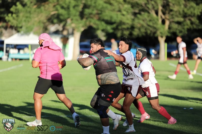 A powerful Rabbitahz forward drives through the middle with Seagulls defenders in white and maroon clinging on either side.