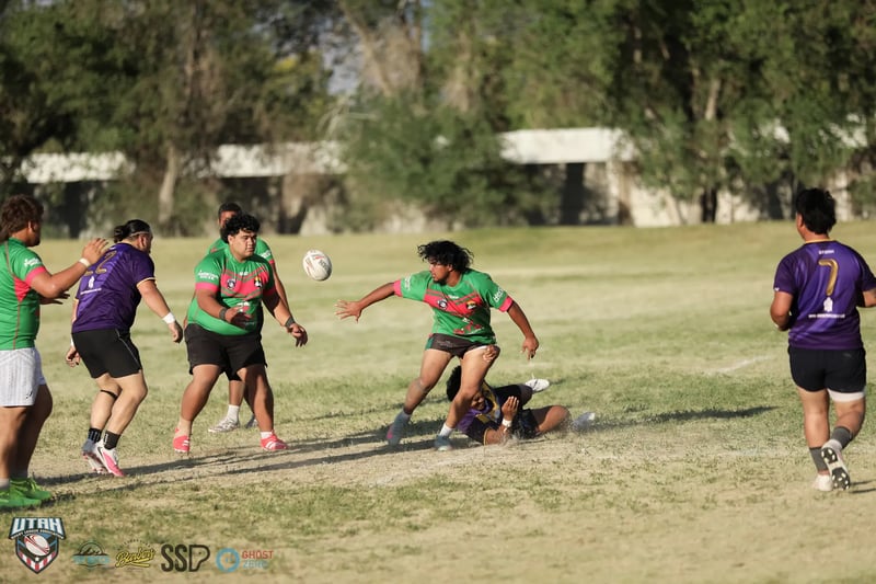 Bluffdale Rabbitahz players in green keep the ball alive with an offload against the Lehi Raiders defence.