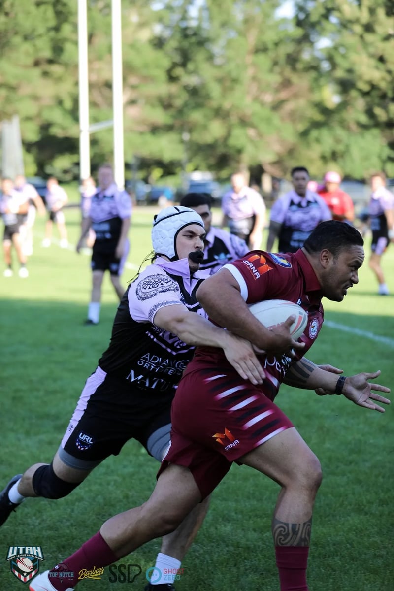 A Riverton Seagulls ball carrier in maroon bursts through a Lehi Raiders defender who has an arm across his chest.