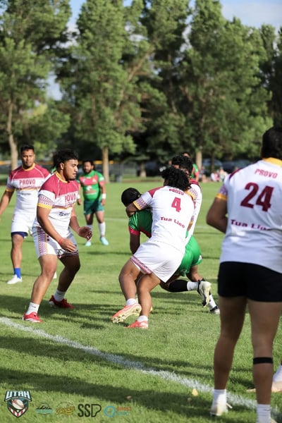 Broncos number 4 drives the ball forward into Rabbitahz defenders