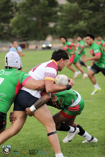 Provo Broncos ball carrier clutches the ball tight as a Rabbitahz defender wraps him up in a close-quarters tackle