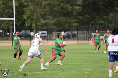 Rabbitahz ball carrier sprints into open space with a Broncos defender in pursuit