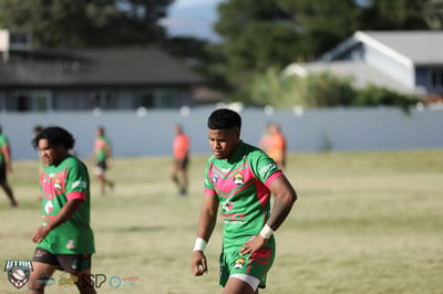 Portrait of a Rabbitahz player in a green jersey with red trim standing on the field between plays