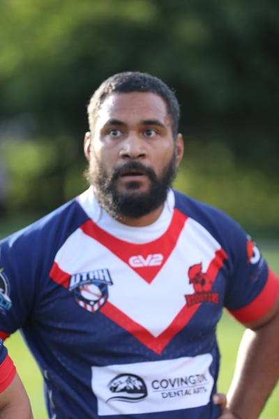 Close-up of a Roosters player in the navy and white jersey looking on